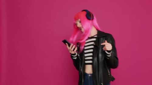 Young Woman with Pink Hair Dancing with Phone