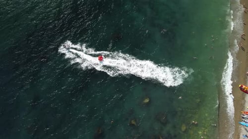 Aerial View of Jet Ski Towing Tube on Beach