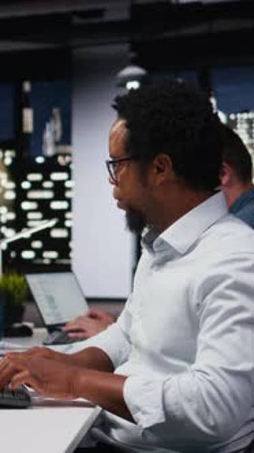 Vertical Video Engineer in Office Receiving Critical Error Warning While Writing Code