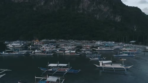 Aerial Drone View of Boats Anchored in the Bay with Clear and Turquoise Water on the Sunset Boat and