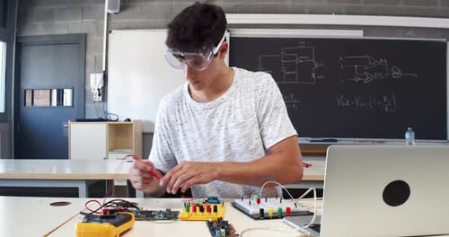 Student Working on Electronics Project in Science Class