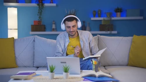 Young Man Studying, Working on Laptop at Home