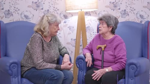 Two Senior Women Friends Talking in Nursing Home
