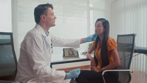 Plastic Surgeon Touching Face of Female Patient