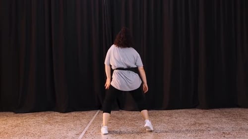 A Female Choreographer Dancing To The Hip Hop Beat In The Studio - full shot