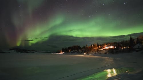 Timelapse of Aurora Borealis above Small Village in Northern Norway