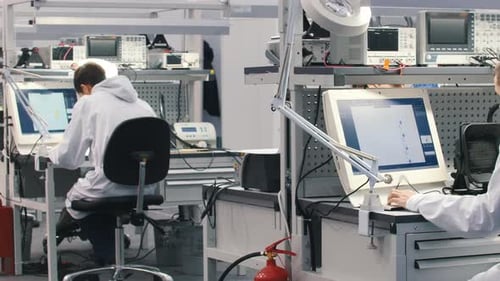 Engineers working on computer screens in a laboratory