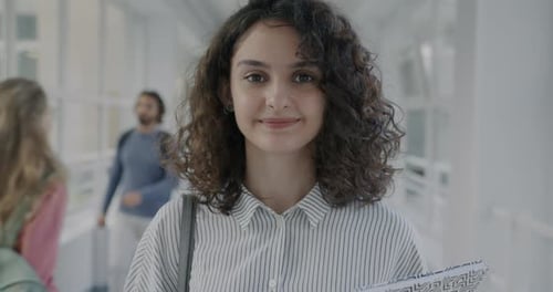 Slow Motion Portrait of Young Woman Student Holding Books Standing in College Lobby Enjoying
