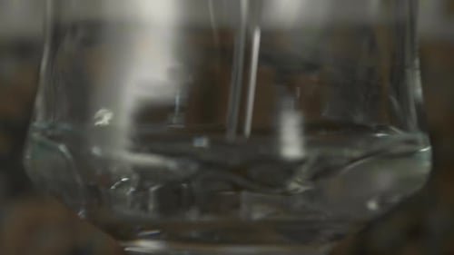 Water Being Poured into Elegant Clear Glass
