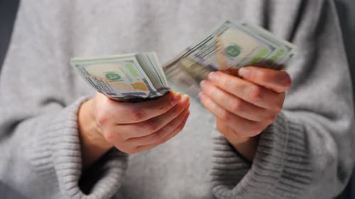 Hands Count Hundred Dollar Bills at Home