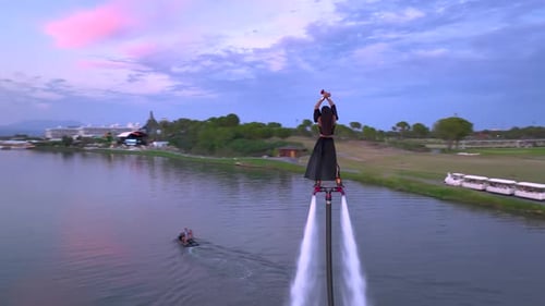 Aerial View Courageous Woman Flyboarding in Twilight