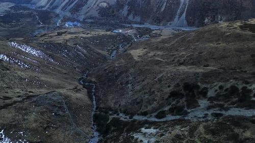 Flying over rocky stone formations terrain in Nepal, steep mountain ranges