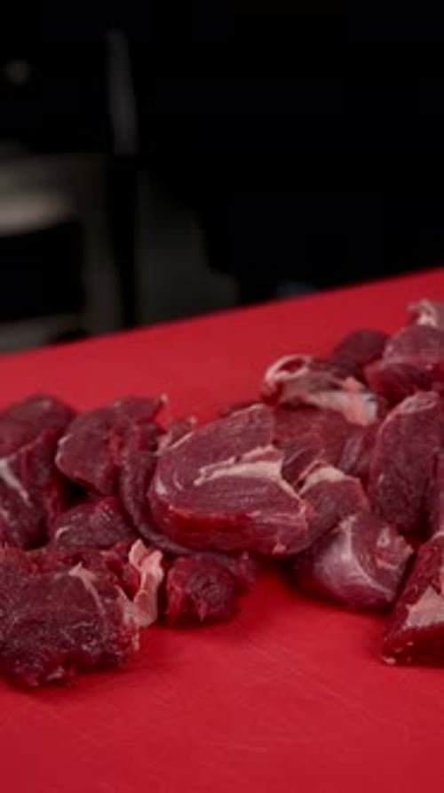 Close Up of Raw Diced Meat on Red Board