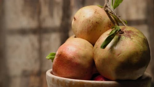Pomegranates in Bowl Rotating Close Up
