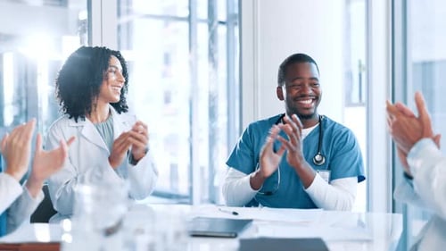 Medical Professionals Clapping in an Office Meeting