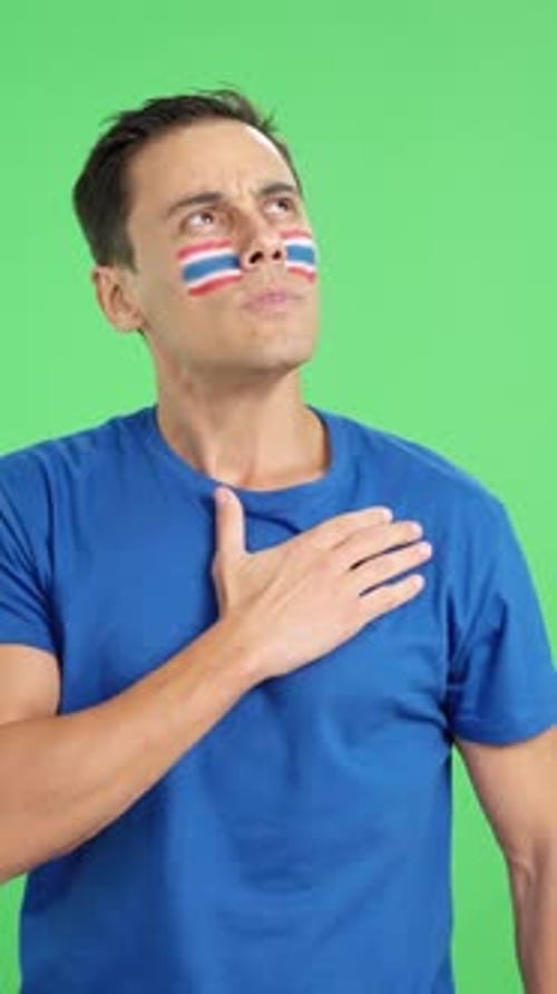 Man Listening to the Thailand National Anthem with Solemnity