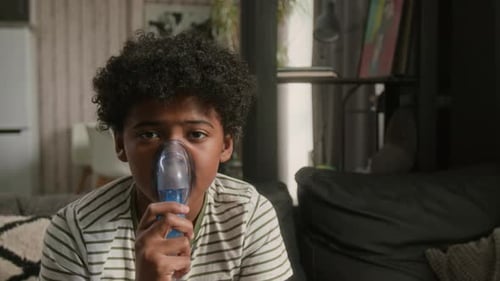 Boy Using Nebulizer Treatment at Home