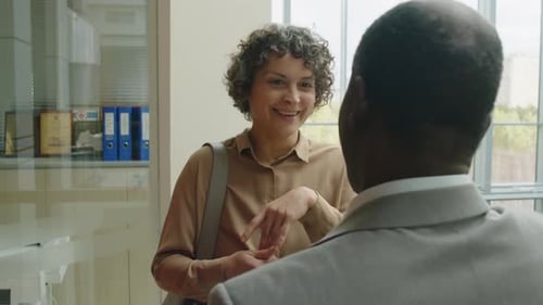 Woman Talking to Man in Modern Office