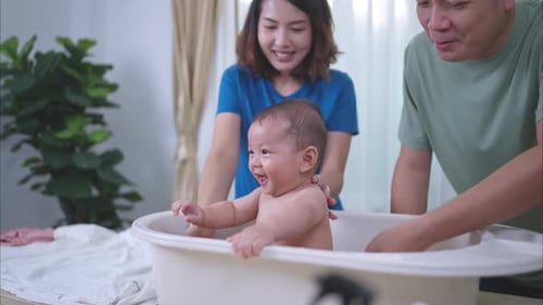 Joyful Baby Splashing in a Tub with Parents
