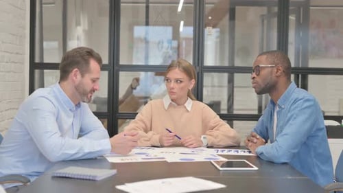 Young Man Talking During Meeting in Office