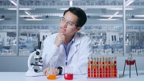 Scientist with Idea Looks Through Microscope in Lab