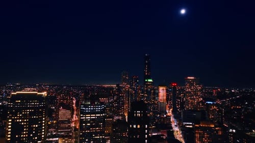 Moon shining in the dark blue sky above the cityscape of amazing New York.
