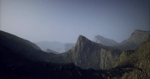 Majestic Mountain Landscape at Twilight with Rugged Peaks and Valleys