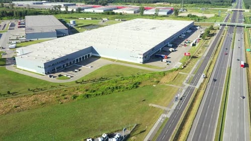 Aerial top view of the large logistics park with warehouse, loading hub with many semi-trailers truc