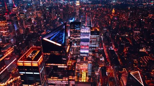 Lively shining New York at night. City scenery above the skyscrapers tops in metropolis downtown.