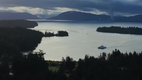 Ferry Crossing Calm Waters Near Thetis Island Under Overcast Sky. Vancouver, Canada. wide shot