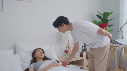 Boyfriend Surprises Girlfriend with Roses in Bedroom