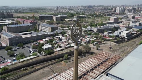 Old Soviet Armenia crest on tall spire over Yerevan railway station