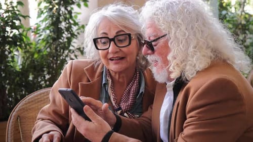 Senior Couple Enjoying Coffee and Phone Together