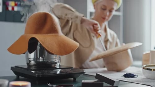 Woman Shaping Hat in Sunny Workshop