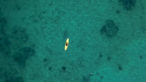 Aerial view of yellow kayak in turquoise sea