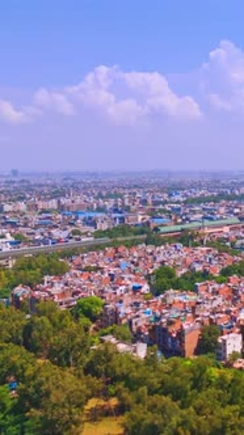 Aerial Drone View of Delhi Metro Passing Through Green Urban Landscape