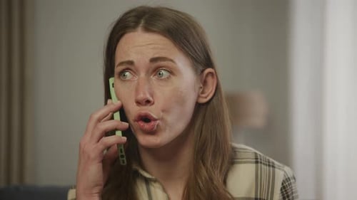 Woman Talks on Phone Expressively Indoors