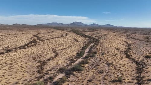 Aerial view of arid desert landscape with mountains, United States.