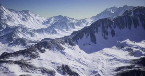Majestic Mountain Range Covered in Snow During Bright Day