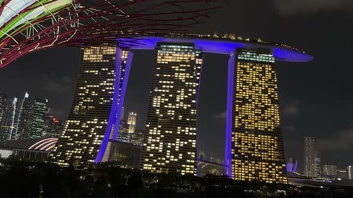 Marina Bay Sands luxury hotel SIngapore at night, room window light on blue exterior