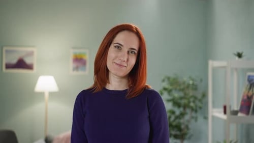 Red Haired Woman Smiling in Her Living Room