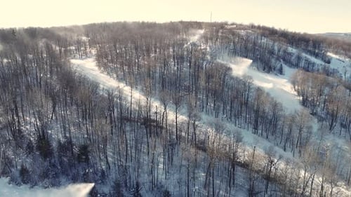 Aerial View of Snowy Ski Slopes and Wintry Forest Ridges