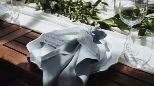 Bride and Groom Place Settings at Wedding Reception Table Closeup Beautiful Plates with a Gold