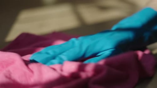 Close up of hand cleaning surface with rag