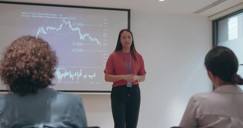 Woman Giving Business Presentation in Conference Room