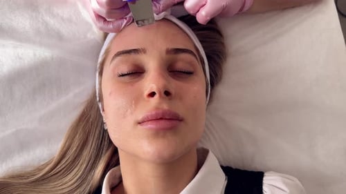 Woman Receives Facial Treatment at Medical Clinic