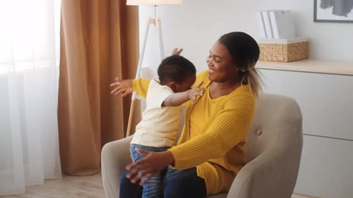 Smiling Woman Hugging Child in Cozy Home Interior