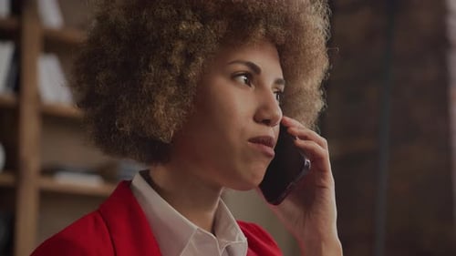 Smiling Businesswoman on Phone Call in Creative Office