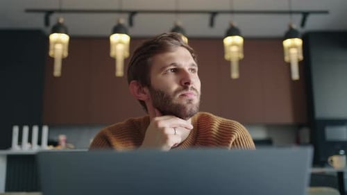 Professional Creative Man Sitting At His Desk In Home Office Studio Working Typing On a Laptop