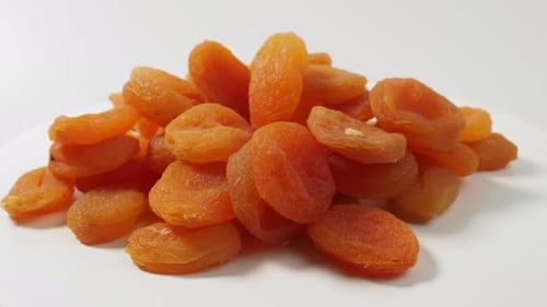 Pile of Dried Apricots on White Background